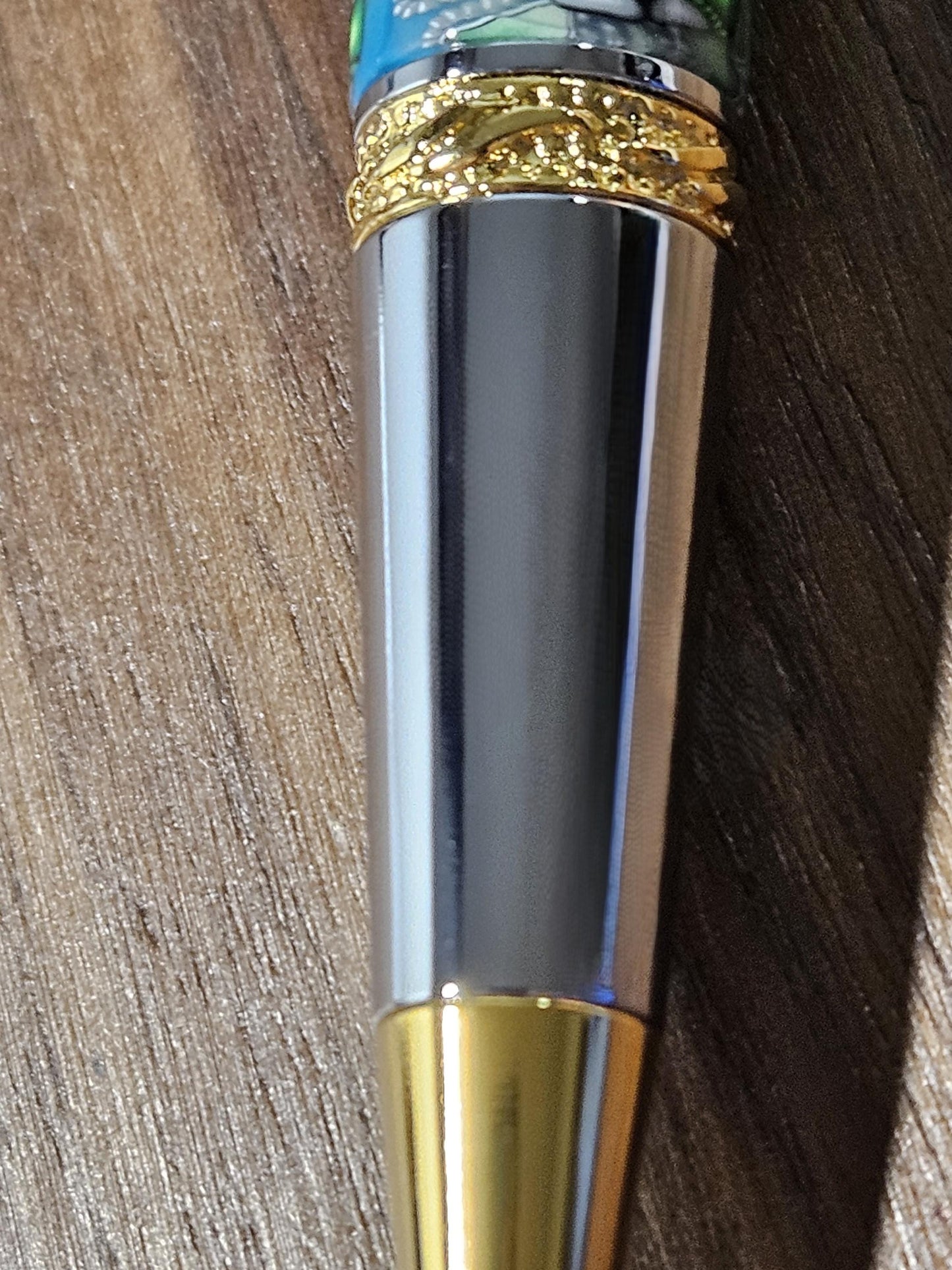 Polymer Clay Gnome Leprechaun Pen with Green Shamrocks, a Blue Background, Chrome and Gold Accents, and Featuring a Majestic Squire Pen Kit