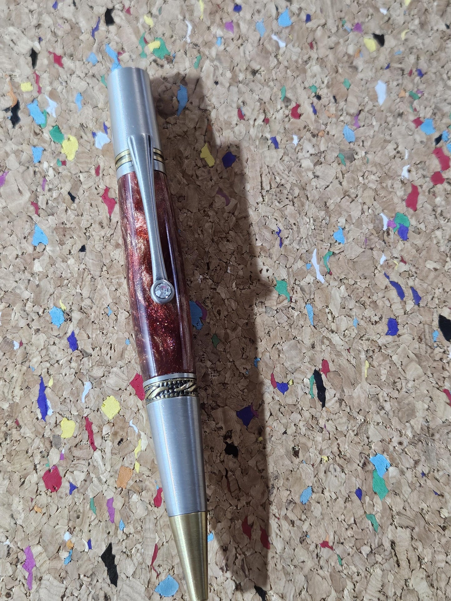 Red Swirled Resin Pen with Glitter and a Majestic Squire Pewter with an Antique Brass Pen Kit Adorned with a Zirconium Gem on the Clip