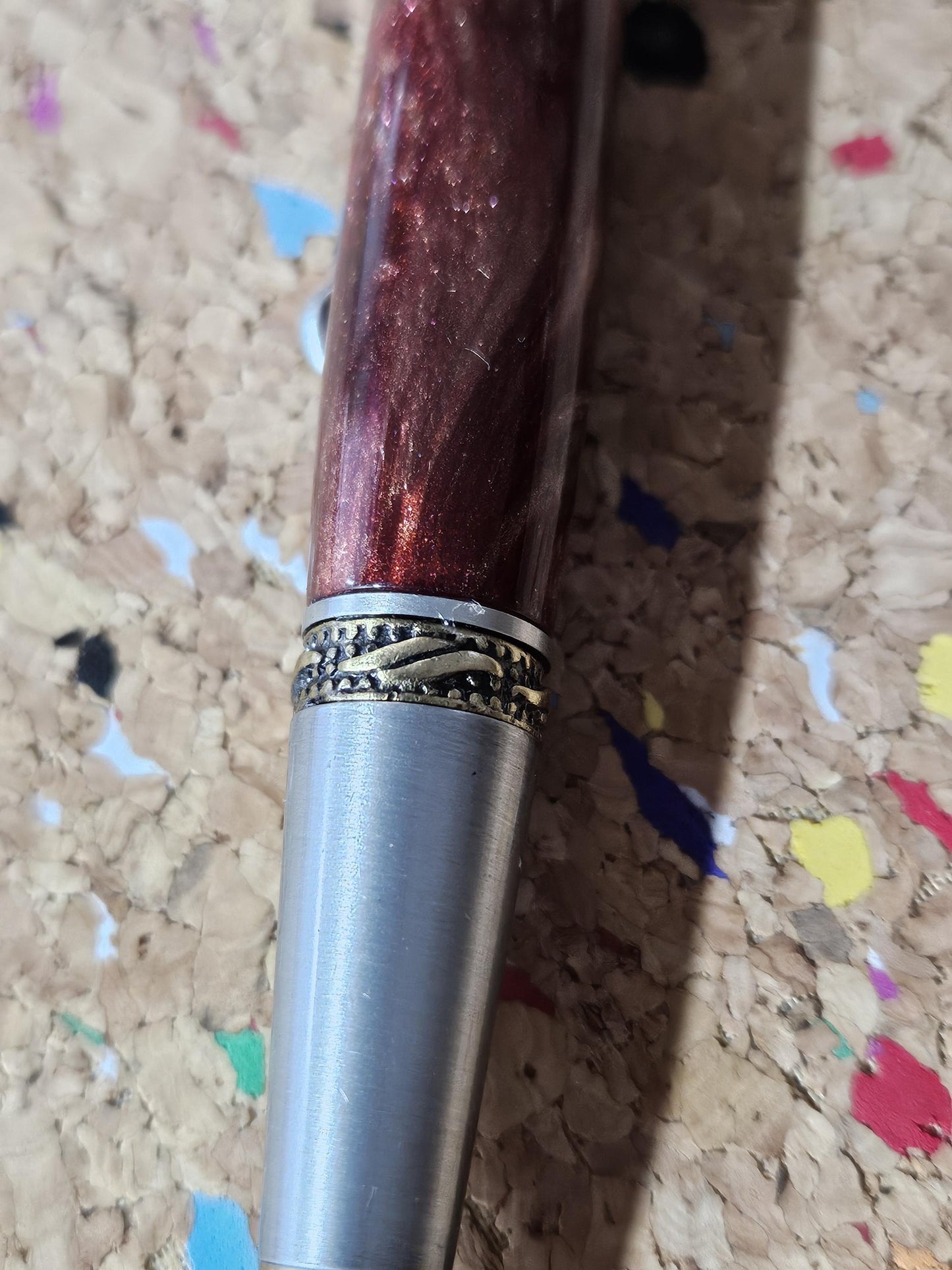 Red Swirled Resin Pen with Glitter and a Majestic Squire Pewter with an Antique Brass Pen Kit Adorned with a Zirconium Gem on the Clip