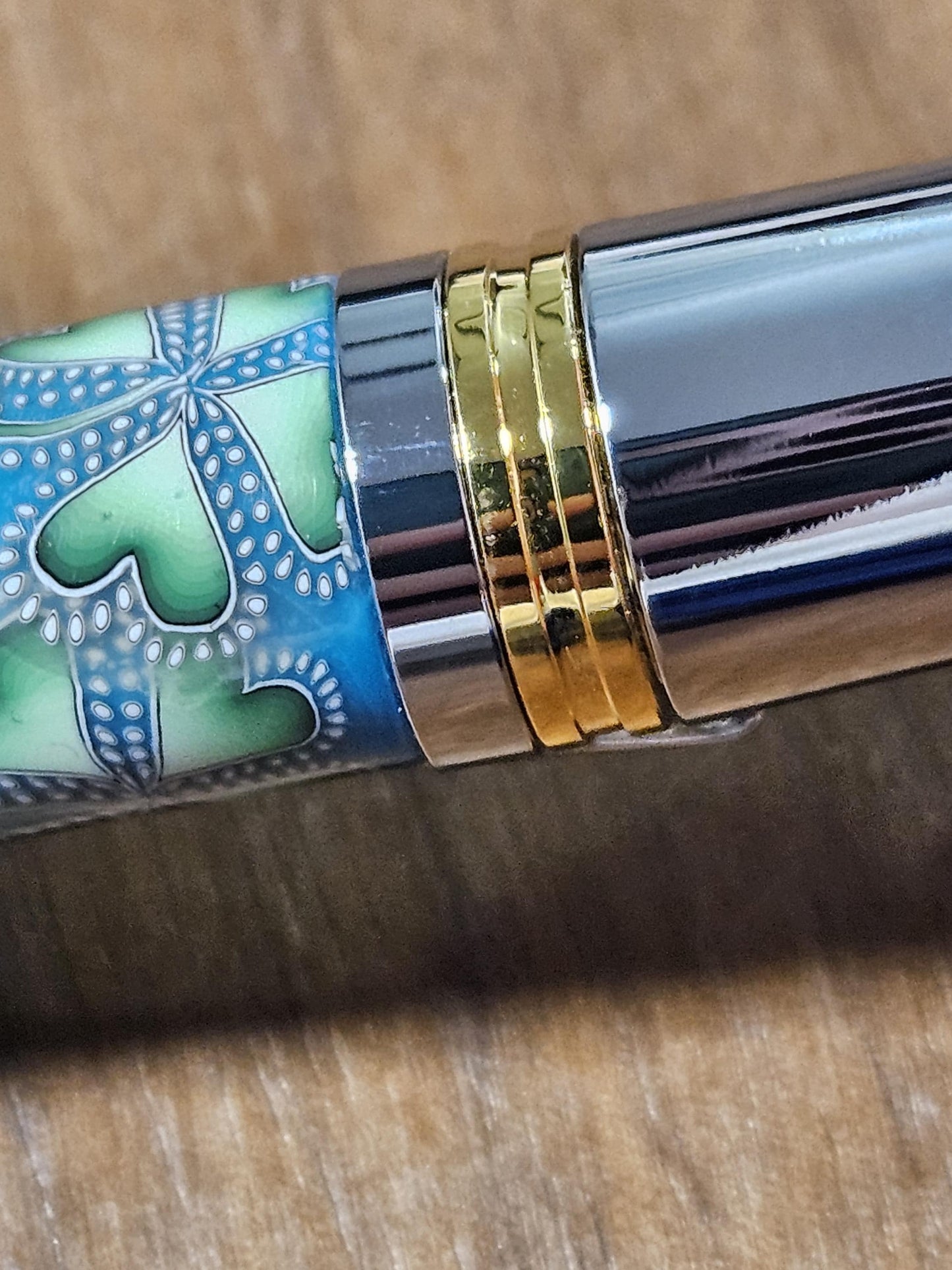 Polymer Clay Gnome Leprechaun Pen with Green Shamrocks, a Blue Background, Chrome and Gold Accents, and Featuring a Majestic Squire Pen Kit