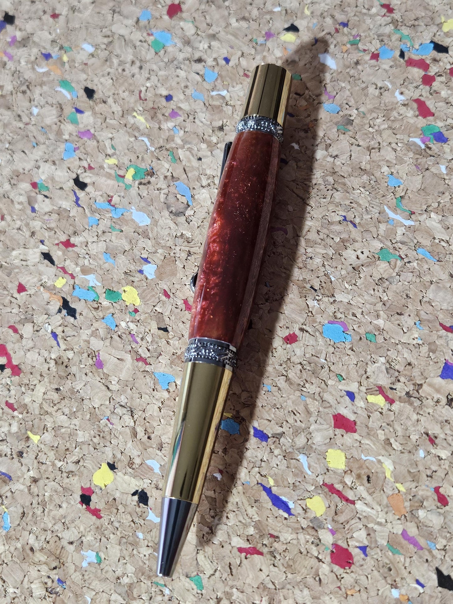 Red Swirled Resin Pen with Glitter and a Majestic Squire Inspired Gold Titanium and Rhodium Pen Kit with a Zirconium Gem on the Clip