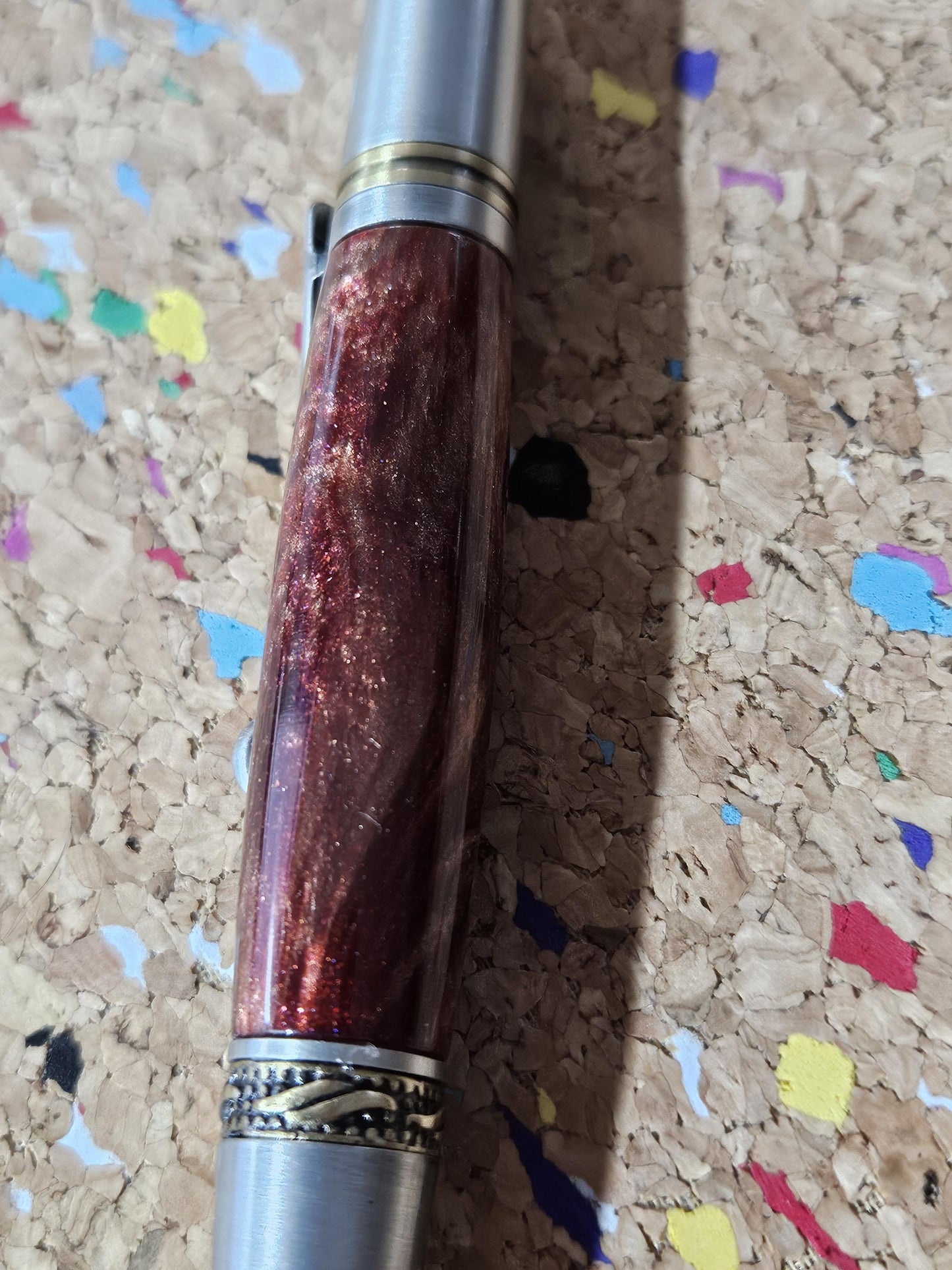 Red Swirled Resin Pen with Glitter and a Majestic Squire Pewter with an Antique Brass Pen Kit Adorned with a Zirconium Gem on the Clip