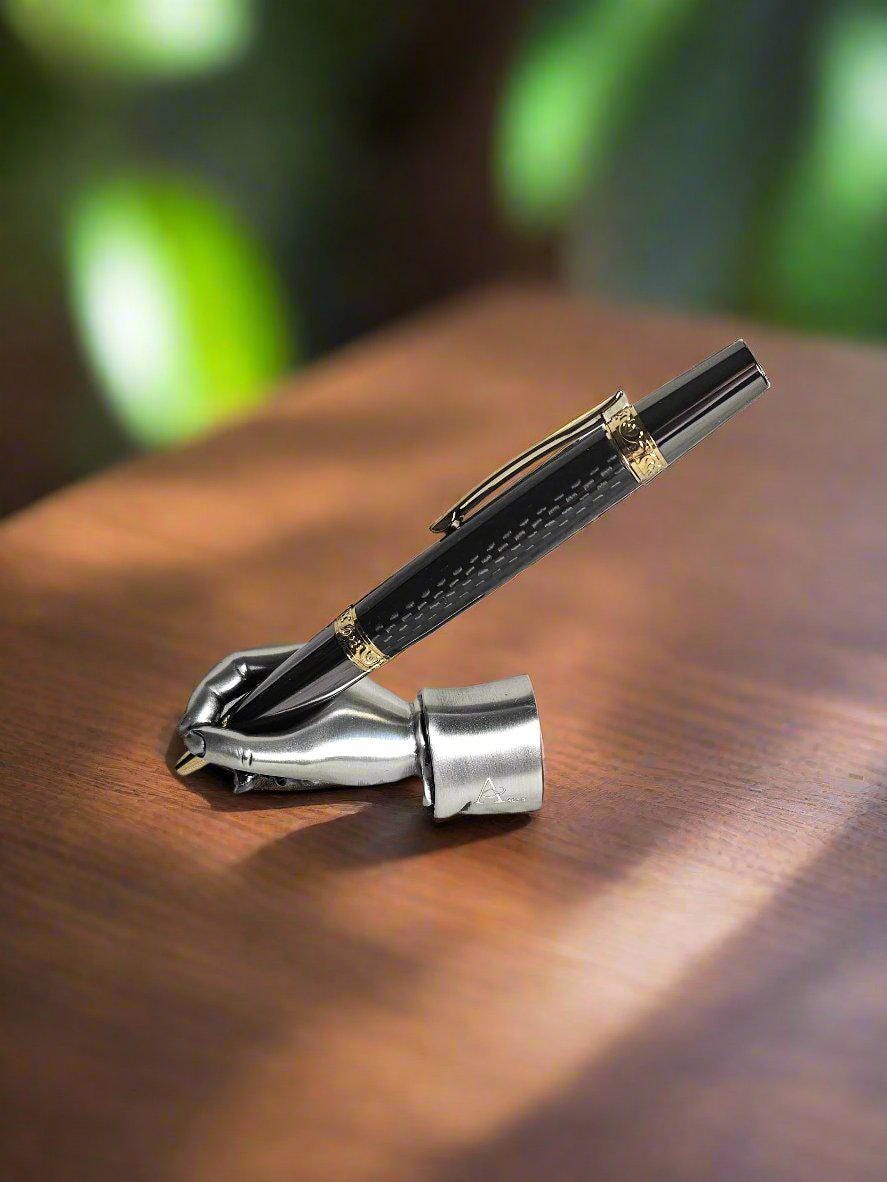 Flat Topped Black Carbon Fiber Sleeve Pen Cast in Resin with a Gold and Gunmetal Pen Kit