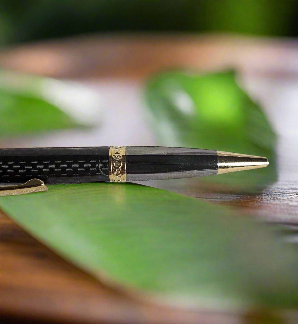 Flat Topped Black Carbon Fiber Sleeve Pen Cast in Resin with a Gold and Gunmetal Pen Kit