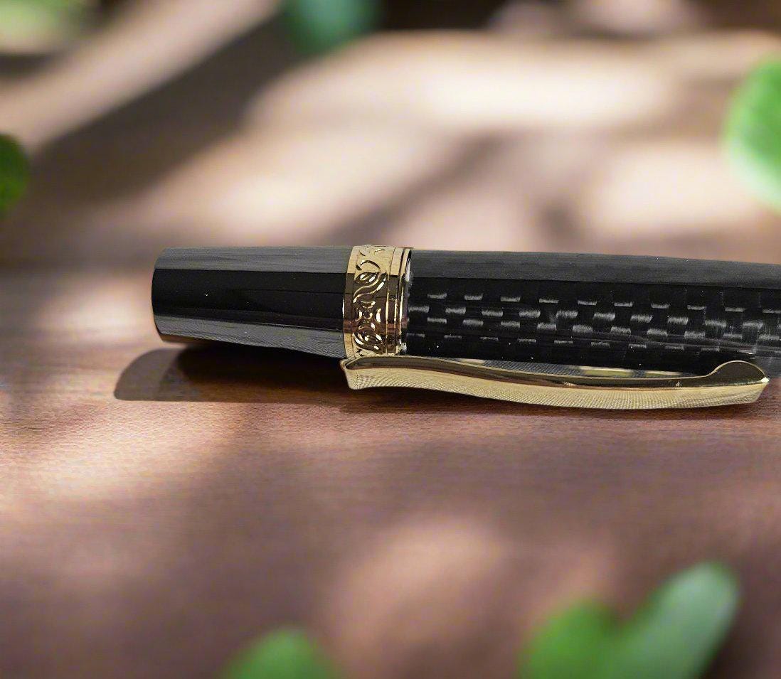 Flat Topped Black Carbon Fiber Sleeve Pen Cast in Resin with a Gold and Gunmetal Pen Kit