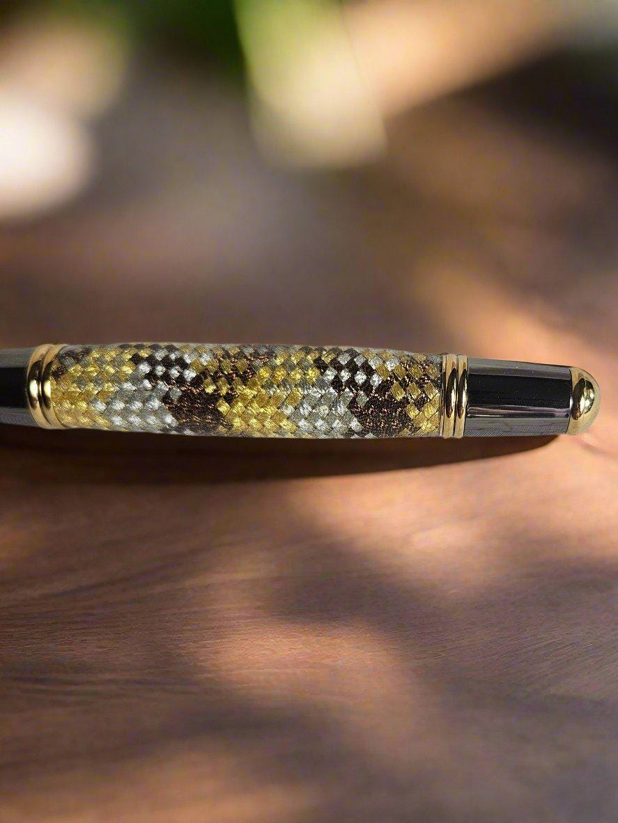 Gold, Silver, and Brown Metallic Braided Carbon Fiber Sleeve Pen Cast in Resin with Gold and Black Chrome and a Hint of Green in the Pen Kit