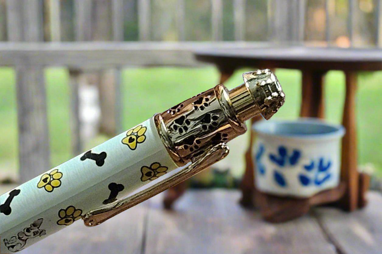 My Dog Loves Me Pen with a Gold Click Top Featuring a Dog Bone, a Dog Bowl, and Doggie Paw Prints