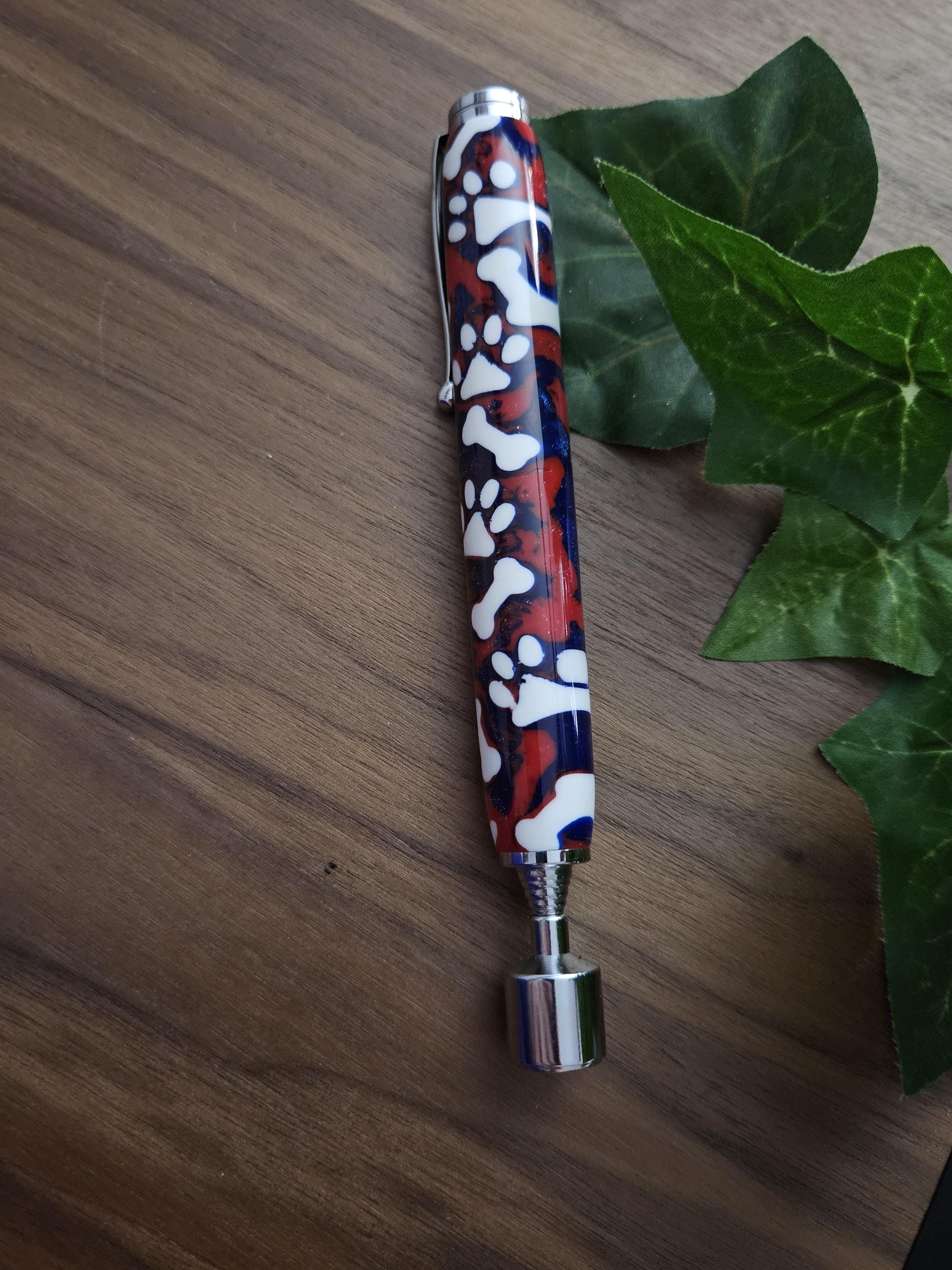 Magnetic Extendable Pickup Tool Featuring White Dog Bones and Puppy Paws on a Background of Glittery Red and Blue with a Chrome Kit
