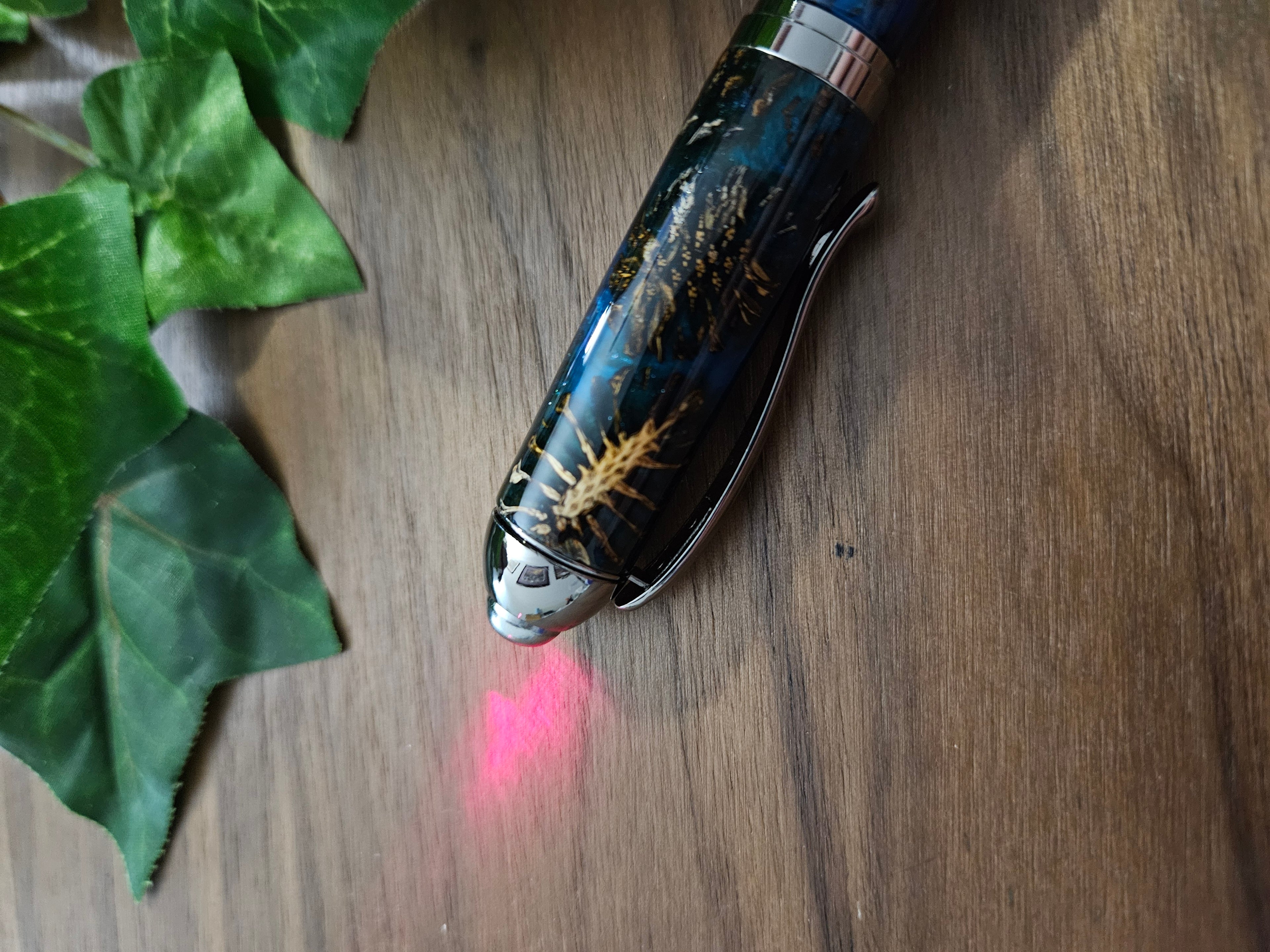 Hybrid Metier Twist Ballpoint Pen with a Red Laser Pointer, Dark Blue Resin, and Pinecone Embeds with a Gunmetal Finish