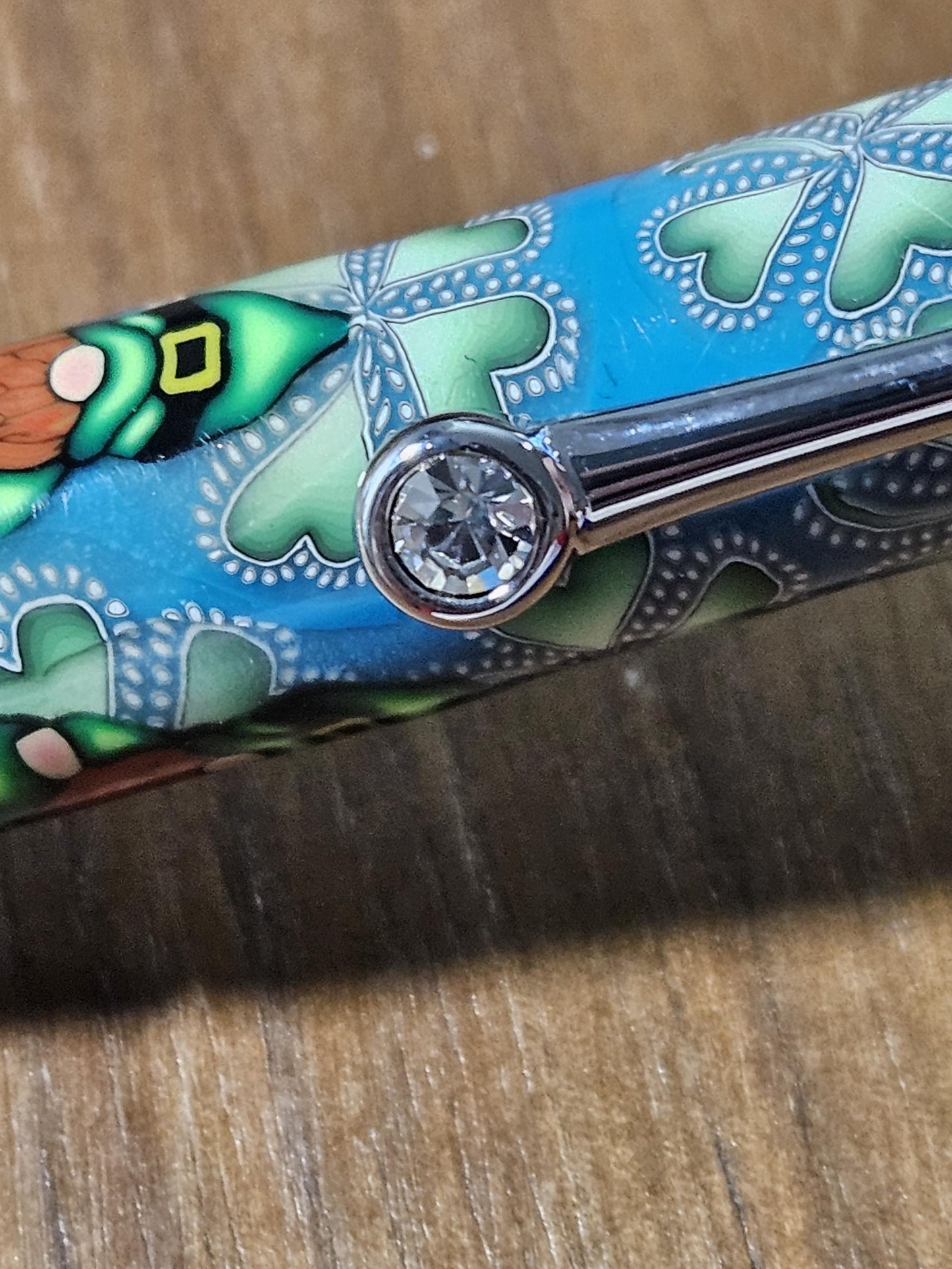 Polymer Clay Gnome Leprechaun Pen with Green Shamrocks, a Blue Background, Chrome and Gold Accents, and Featuring a Majestic Squire Pen Kit