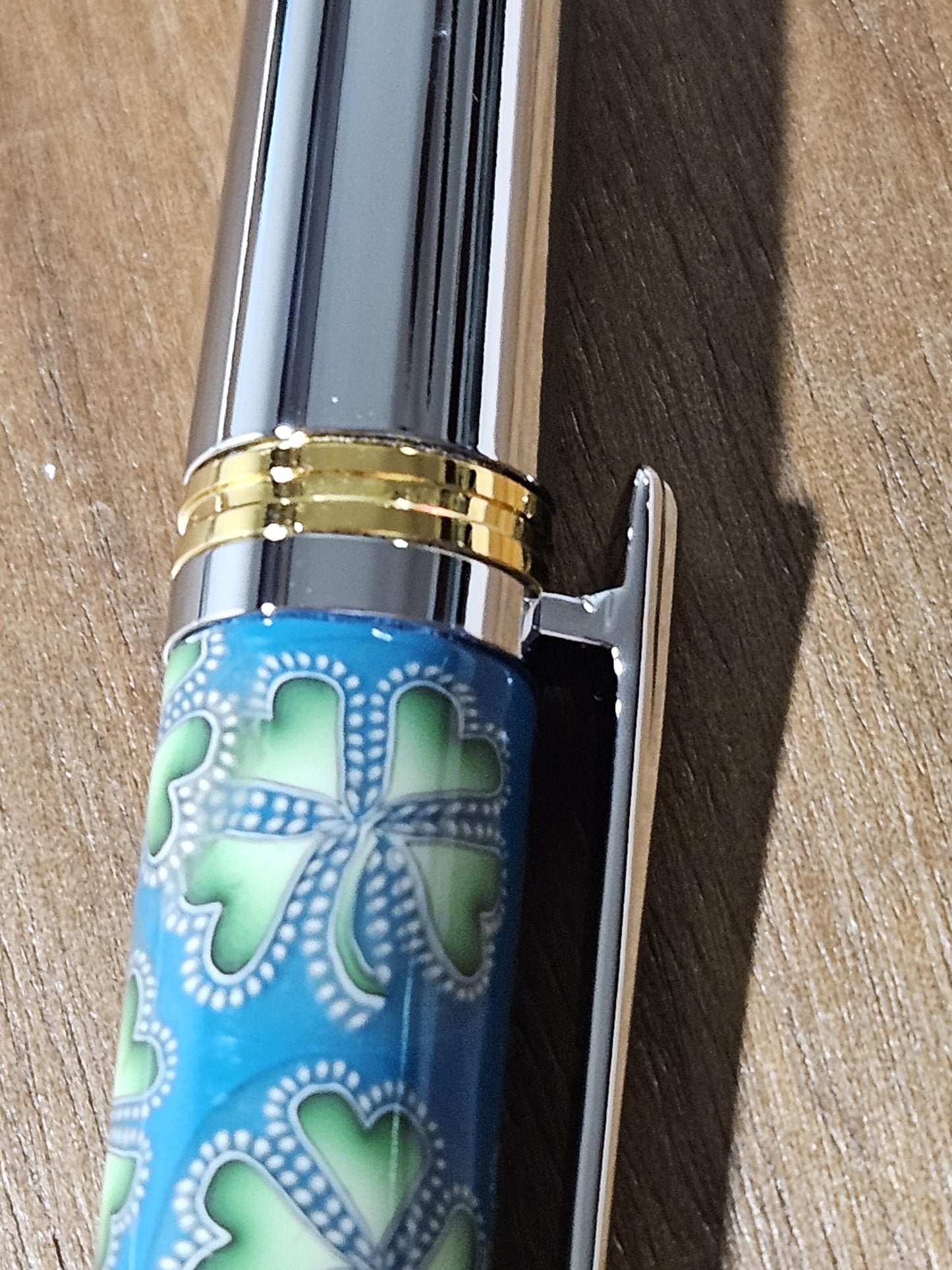 Polymer Clay Gnome Leprechaun Pen with Green Shamrocks, a Blue Background, Chrome and Gold Accents, and Featuring a Majestic Squire Pen Kit