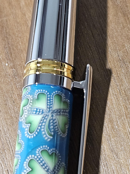 Polymer Clay Gnome Leprechaun Pen with Green Shamrocks, a Blue Background, Chrome and Gold Accents, and Featuring a Majestic Squire Pen Kit