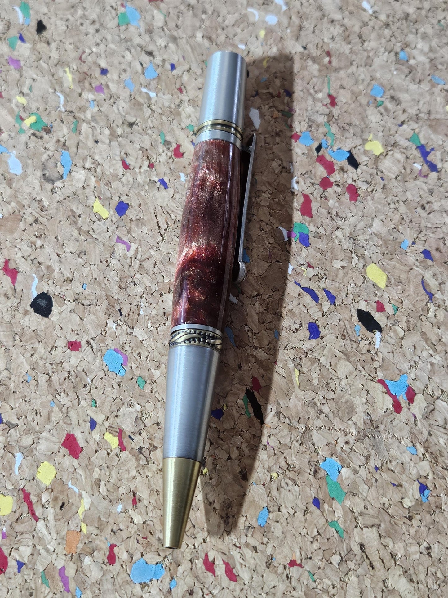 Red Swirled Resin Pen with Glitter and a Majestic Squire Pewter with an Antique Brass Pen Kit Adorned with a Zirconium Gem on the Clip
