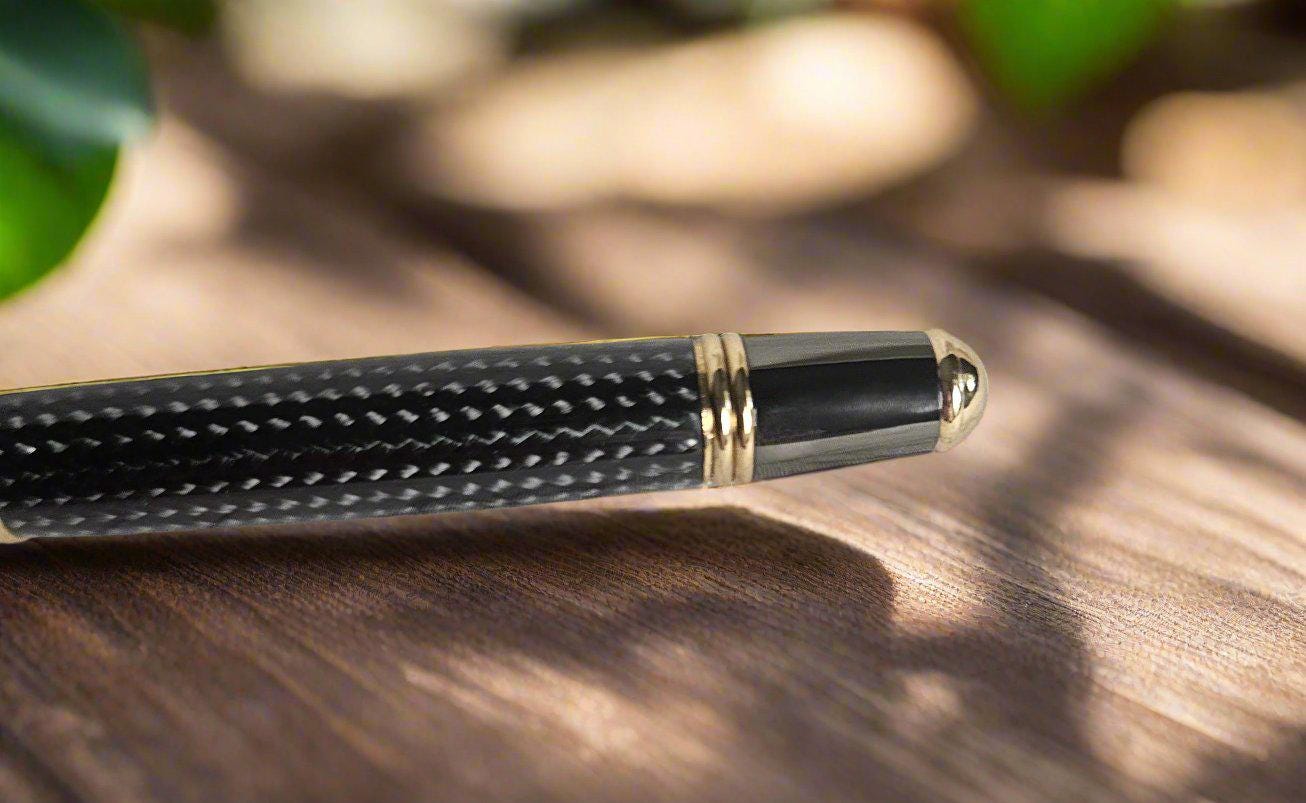Round Top Black Carbon Fiber Sleeve Pen Cast in Resin with a Gold and Gunmetal Pen Kit