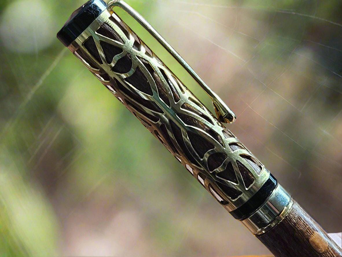 Haunted Halloween Lacewood Capped Rollerball Pen with a Golden Spider Web overlay and a Gold and Black Chrome Pen Kit