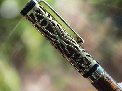 Haunted Halloween Lacewood Capped Rollerball Pen with a Golden Spider Web overlay and a Gold and Black Chrome Pen Kit