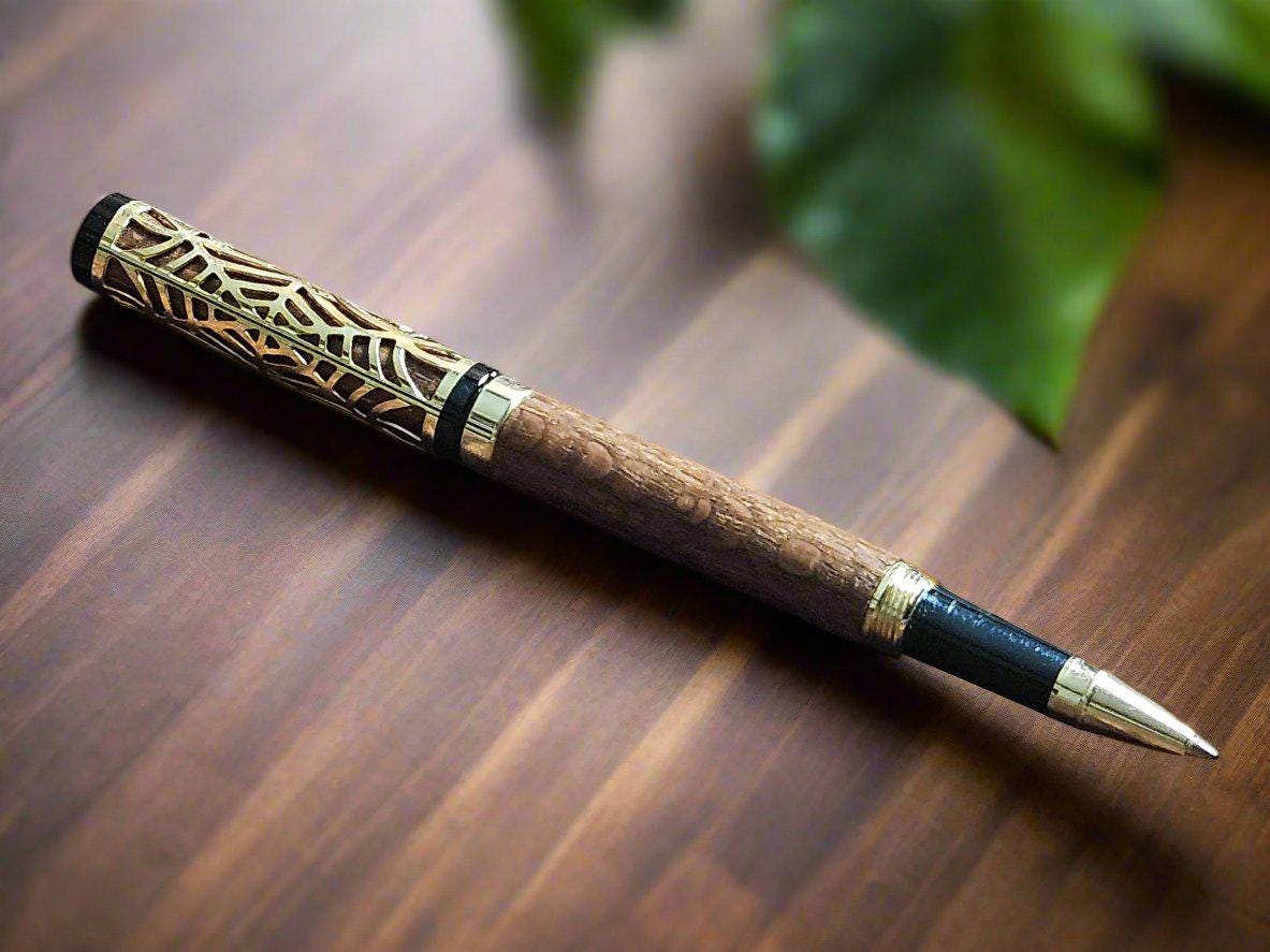 Haunted Halloween Lacewood Capped Rollerball Pen with a Golden Spider Web overlay and a Gold and Black Chrome Pen Kit
