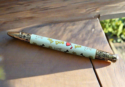 My Dog Loves Me Pen with a Gold Click Top Featuring a Dog Bone, a Dog Bowl, and Doggie Paw Prints