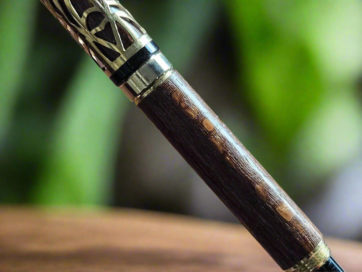 Haunted Halloween Lacewood Capped Rollerball Pen with a Golden Spider Web overlay and a Gold and Black Chrome Pen Kit
