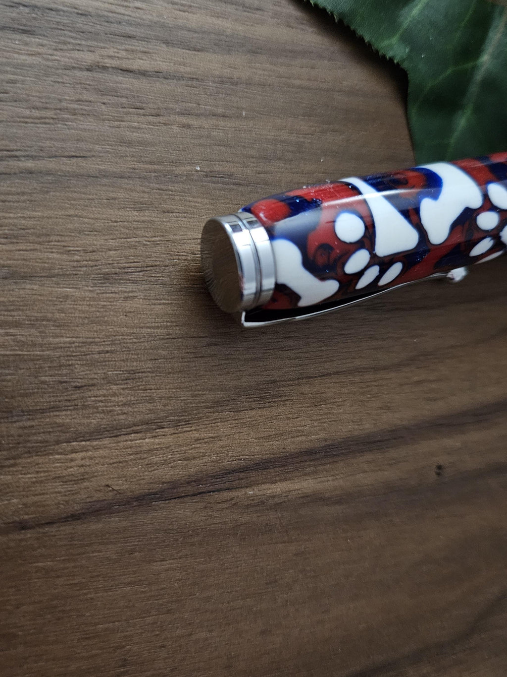 Magnetic Extendable Pickup Tool Featuring White Dog Bones and Puppy Paws on a Background of Glittery Red and Blue with a Chrome Kit