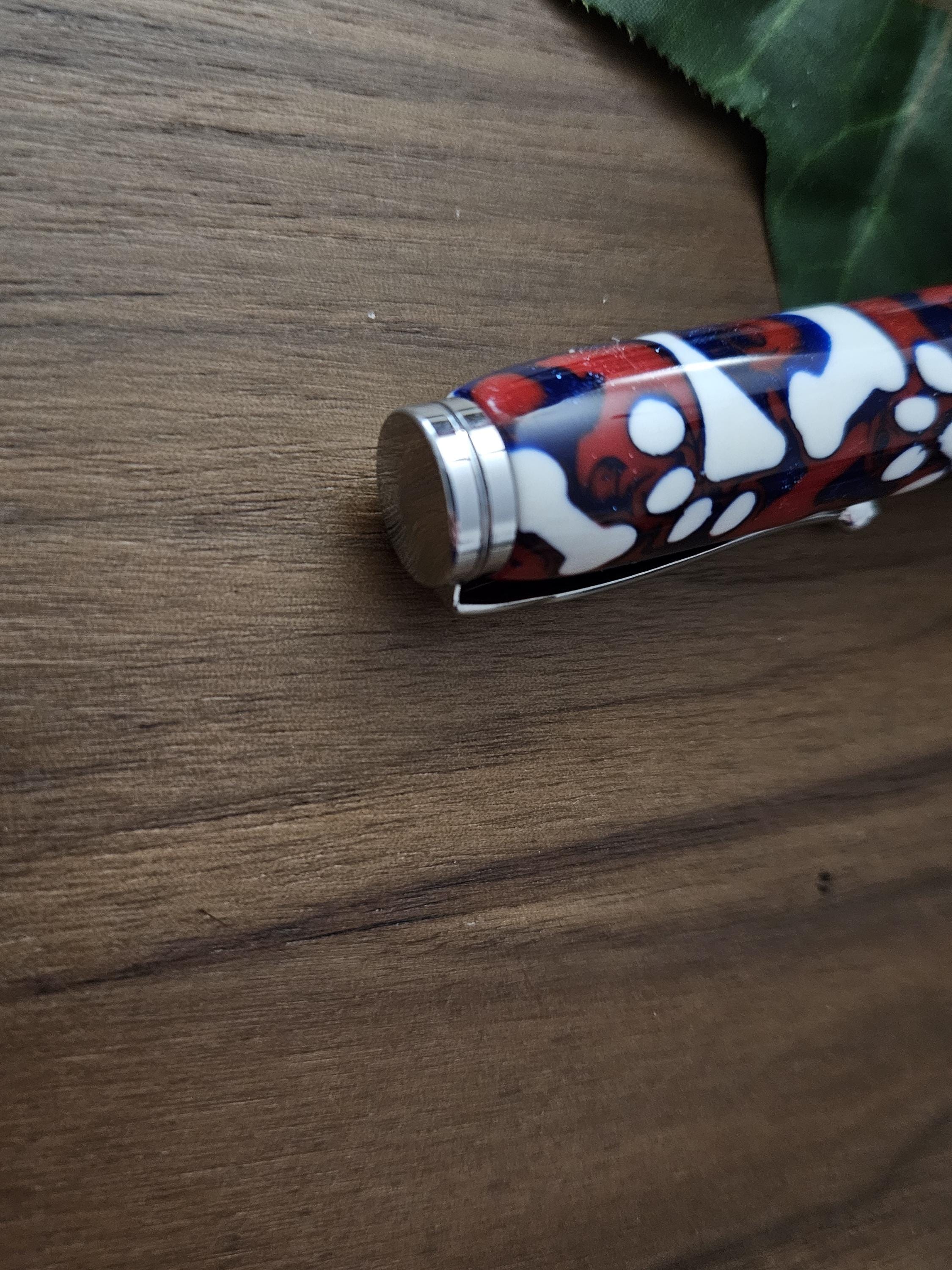 Magnetic Extendable Pickup Tool Featuring White Dog Bones and Puppy Paws on a Background of Glittery Red and Blue with a Chrome Kit