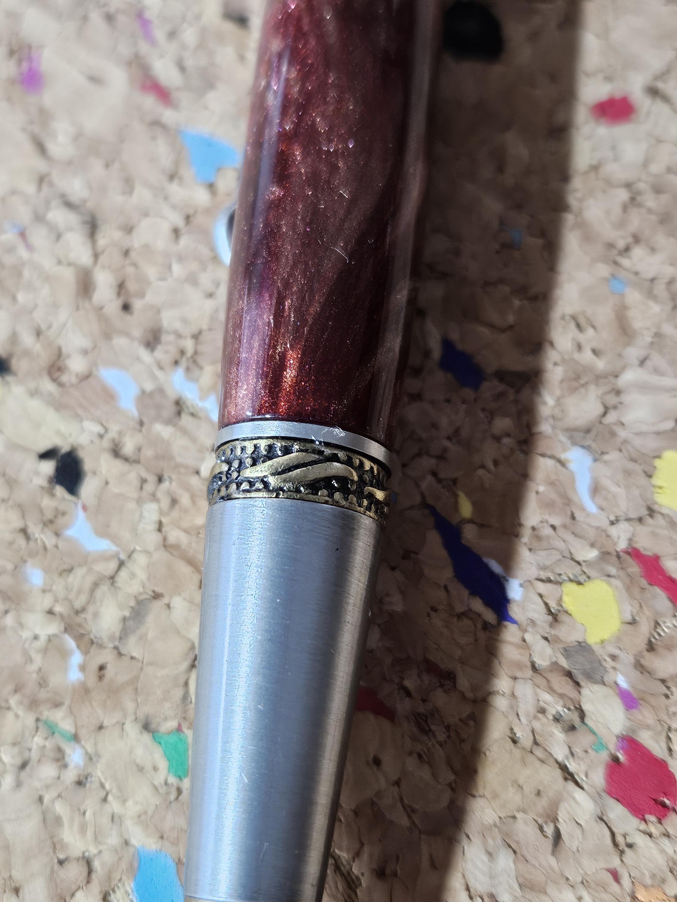 Red Swirled Resin Pen with Glitter and a Majestic Squire Pewter with an Antique Brass Pen Kit Adorned with a Zirconium Gem on the Clip