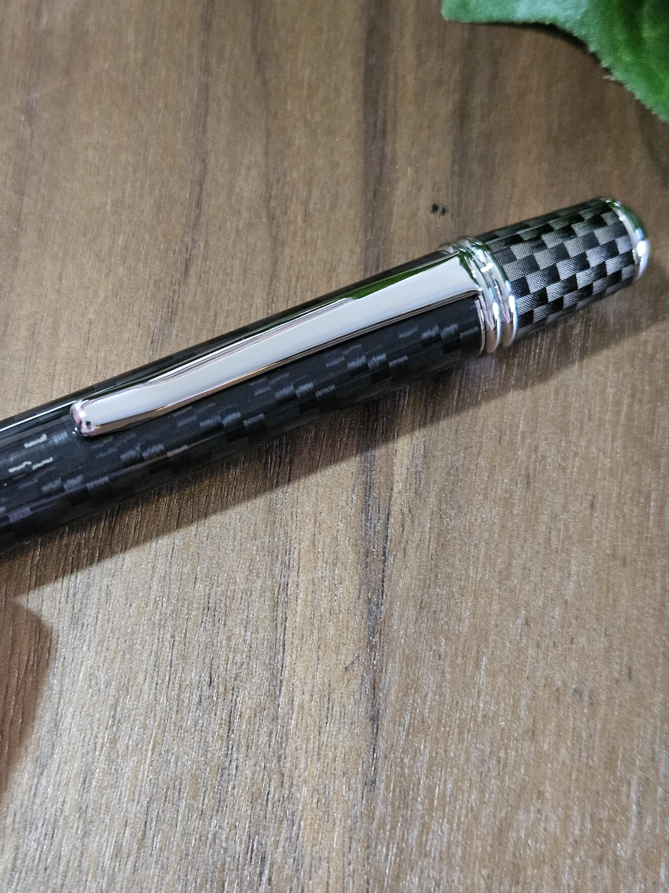 Shades of Black Carbon Fiber Cast in Clear Resin Twist Pen with Faux Carbon Fiber Finial and Tapered Grip with Chrome Accents