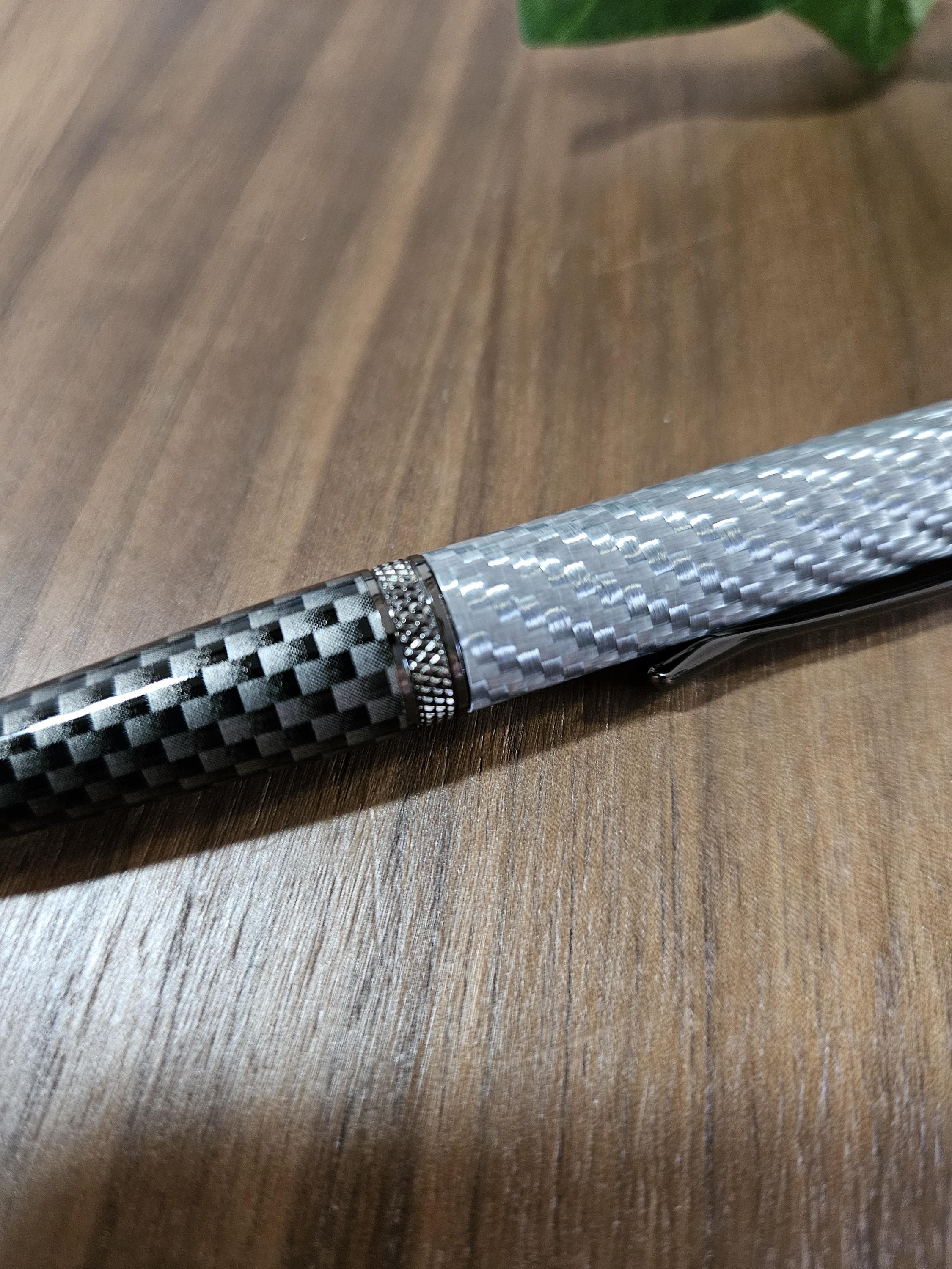 Shades of Silver Carbon Fiber Cast in Clear Resin Twist Pen with Faux Carbon Fiber Finial and Tapered Grip with Gunmetal Accents