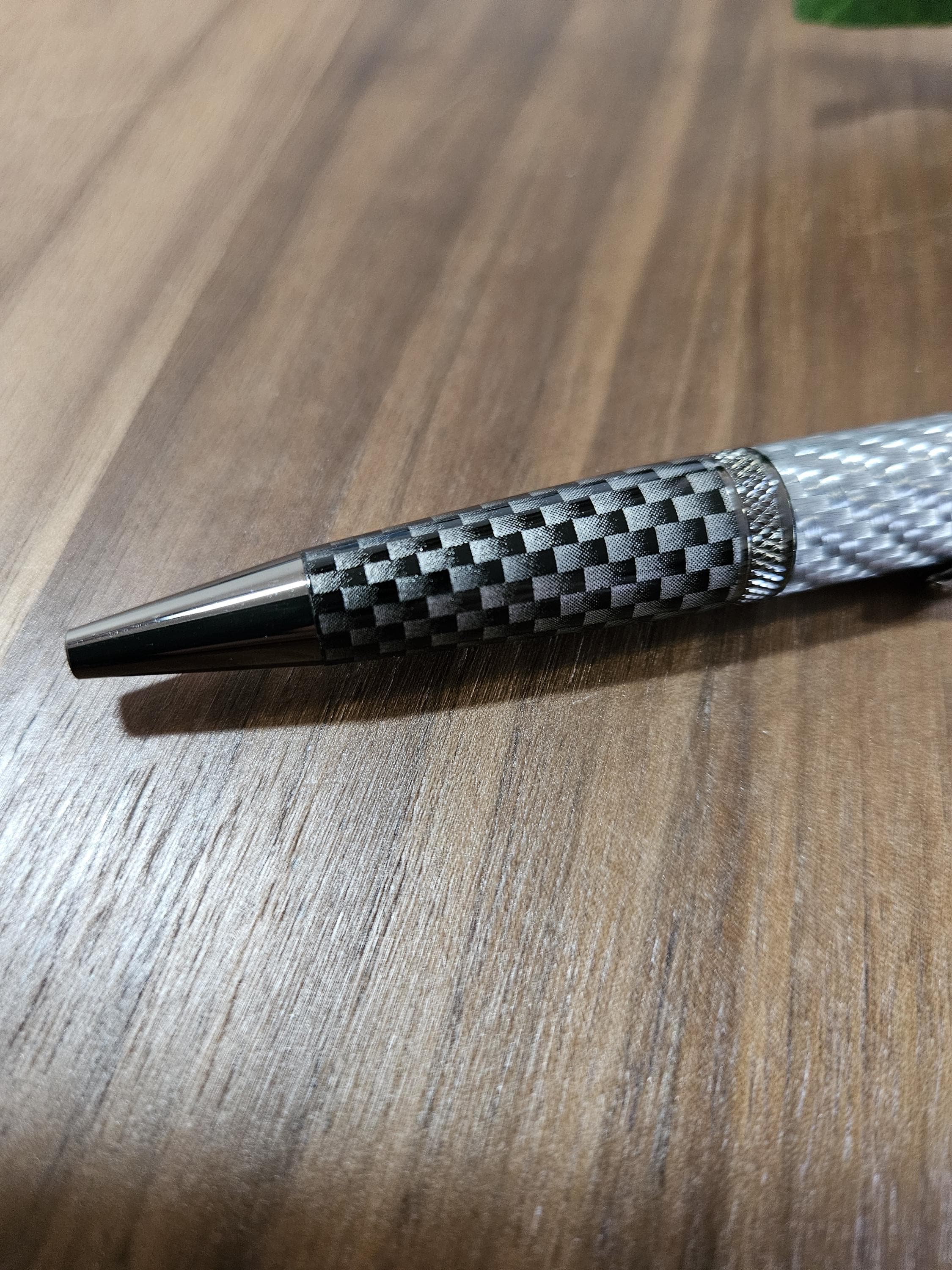 Shades of Silver Carbon Fiber Cast in Clear Resin Twist Pen with Faux Carbon Fiber Finial and Tapered Grip with Gunmetal Accents