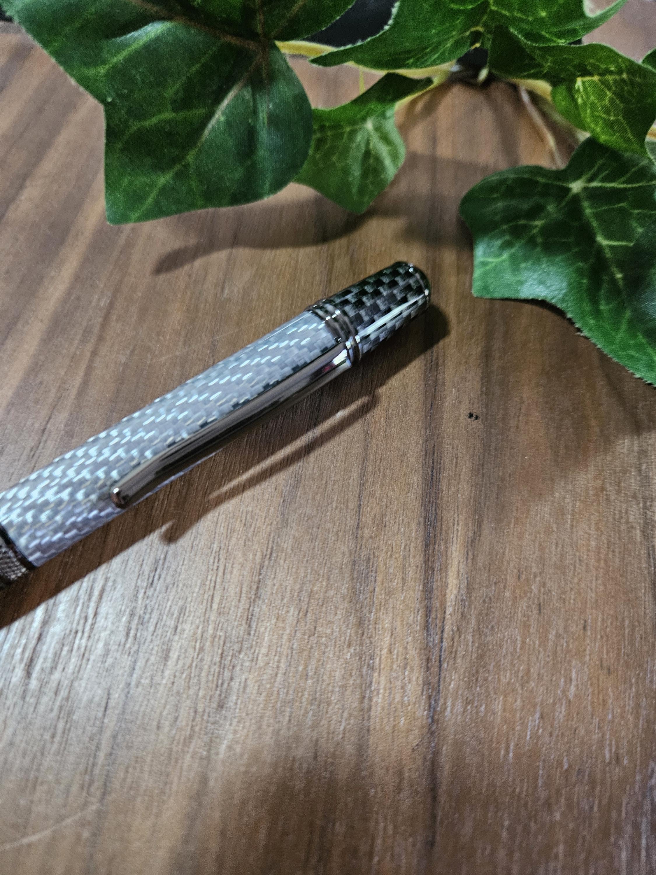 Shades of Silver Carbon Fiber Cast in Clear Resin Twist Pen with Faux Carbon Fiber Finial and Tapered Grip with Gunmetal Accents