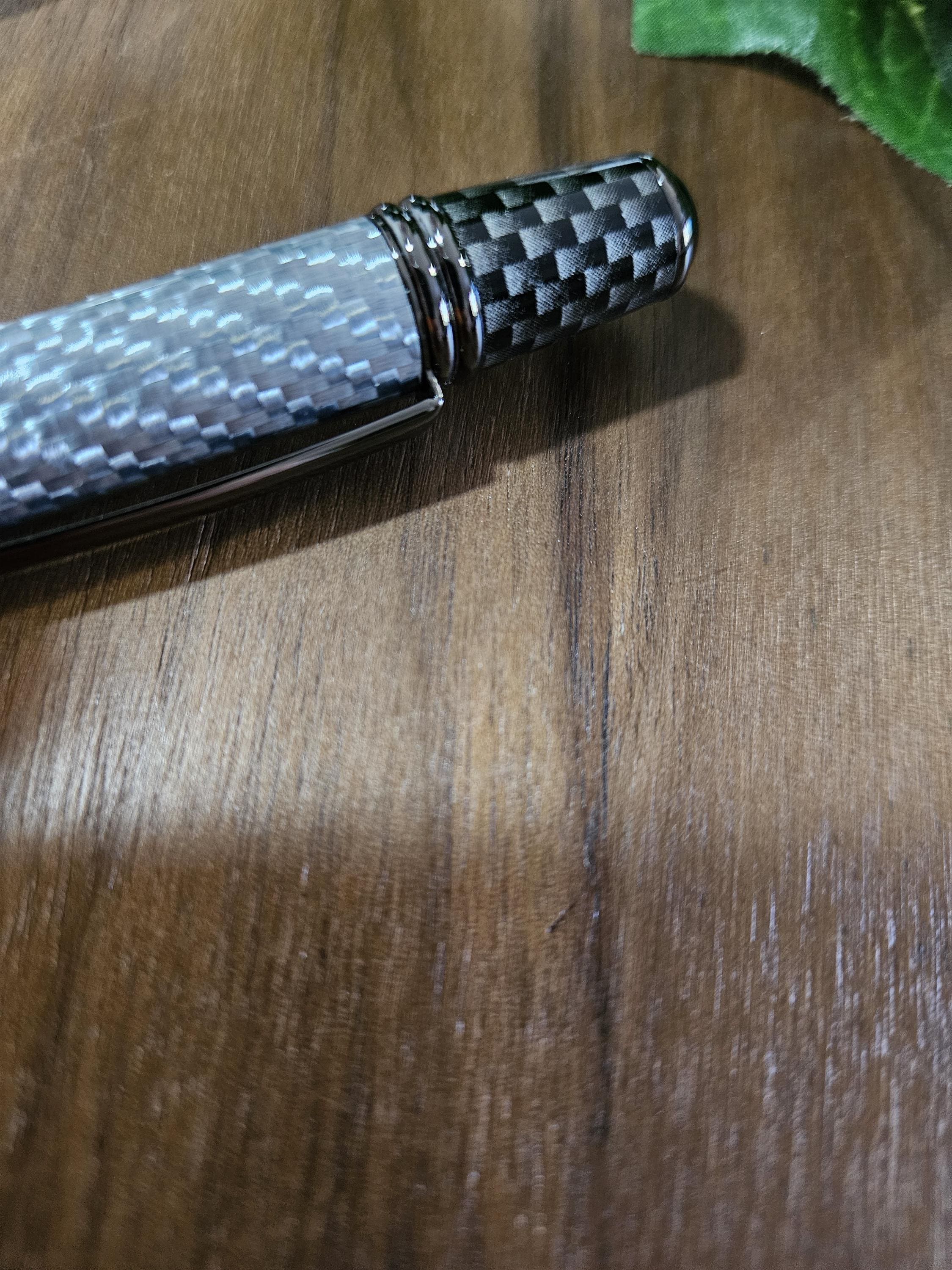 Shades of Silver Carbon Fiber Cast in Clear Resin Twist Pen with Faux Carbon Fiber Finial and Tapered Grip with Gunmetal Accents